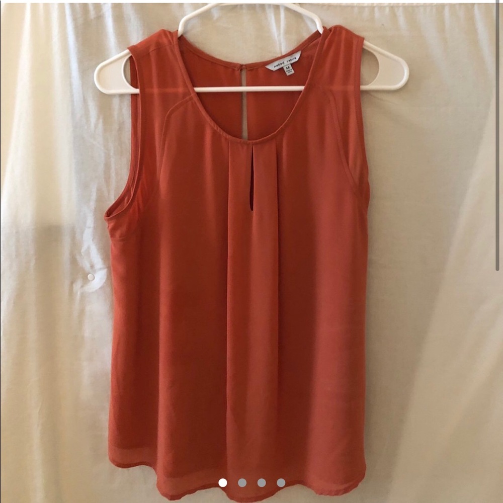 No sleeve salmon red colored flowy blouse.
